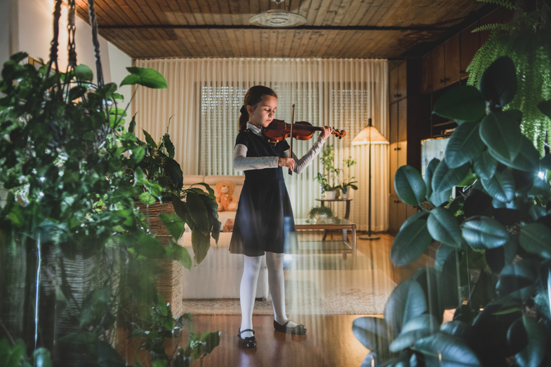Professional photo of a child playing the violin.